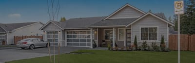Exterior view of a senior living facility with a landscaped yard