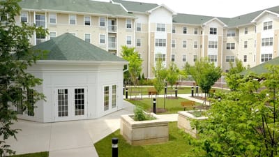 Exterior view of the senior living facility with landscaped gardens