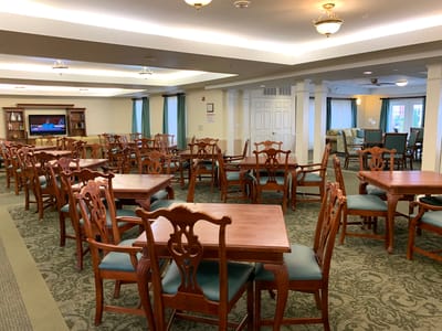 Dining area with wooden tables and chairs in a bright space