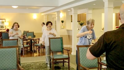 Residents participating in a group exercise activity inside the facility