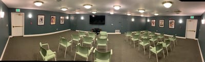 Interior view of a common area with chairs and a TV