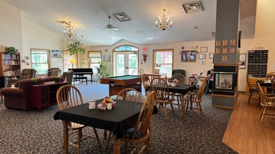 Common area with tables and seating in a light-filled space