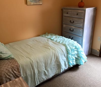 Cozy resident room with a bed and dresser