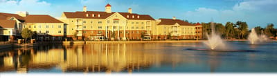 Exterior view of The Oaks of Louisiana by a lake