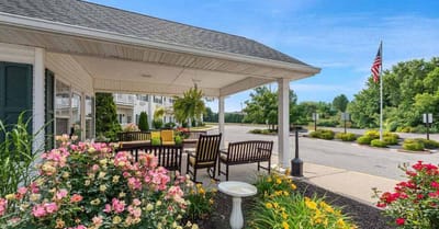 Outdoor seating area with flowers and building entrance