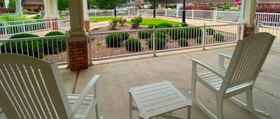 Patio area with rocking chairs and landscaped garden