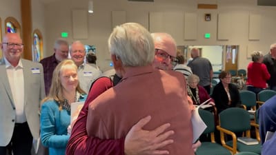Residents warmly greeting each other in a communal space
