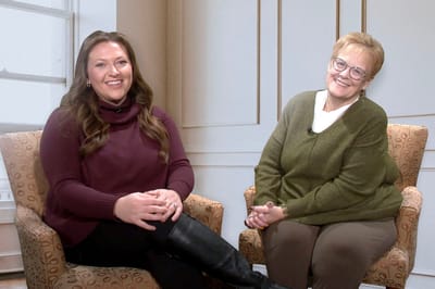Two women sitting in a cozy indoor setting