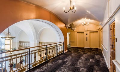 Well-lit interior hallway with decorative arches