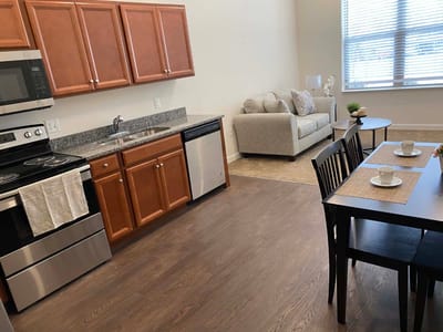 Interior view of a kitchen and living area in a senior unit