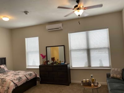 Cozy interior of a private resident room with a bed and furniture