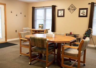 Bright common area with tables and chairs.