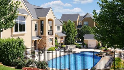 Outdoor pool area with surrounding buildings and greenery
