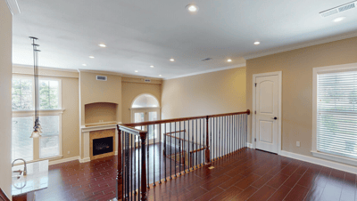 A spacious interior view of a living area with a balcony
