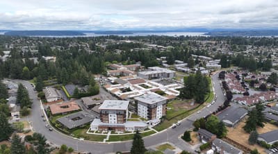 Aerial view of a senior living campus surrounded by trees