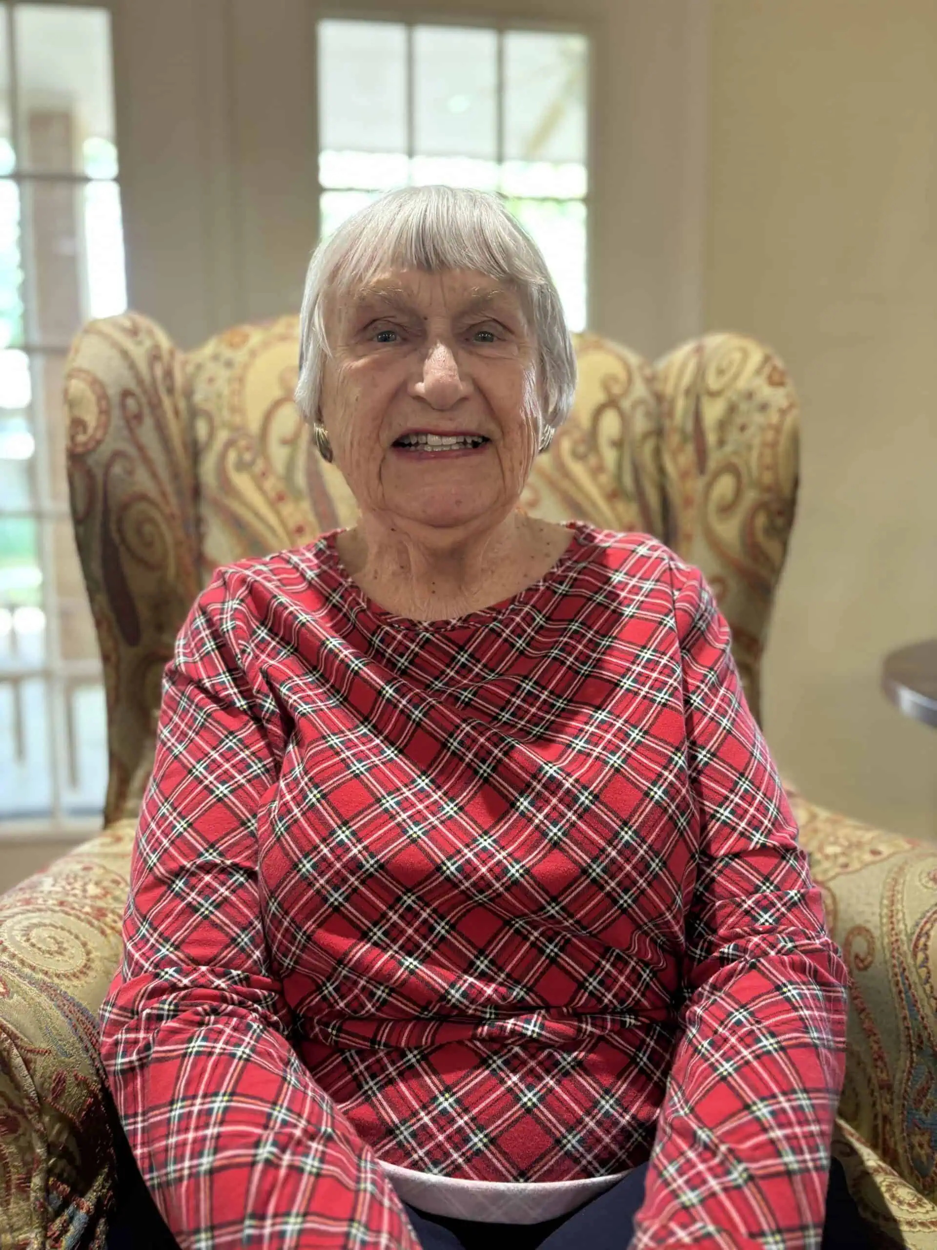 Resident smiling in an armchair