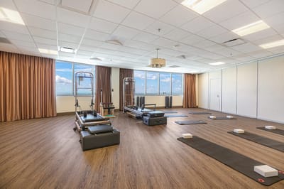 Interior fitness room with exercise equipment and natural light