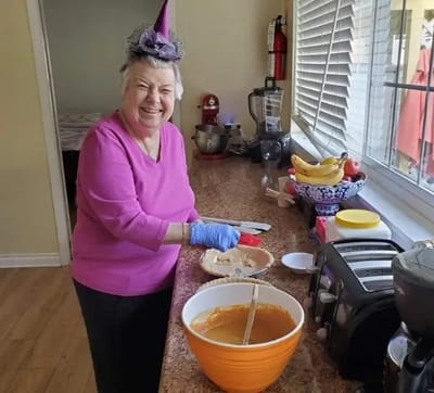 Resident baking in a cheerful kitchen setting