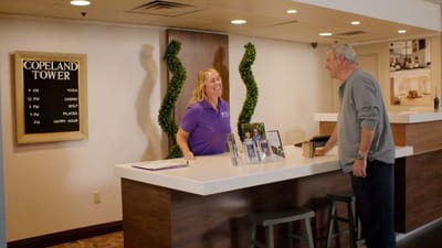 Staff member interacting with a resident in the lobby