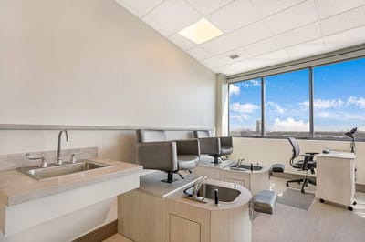 Interior view of a nail salon setup with chairs and a sink