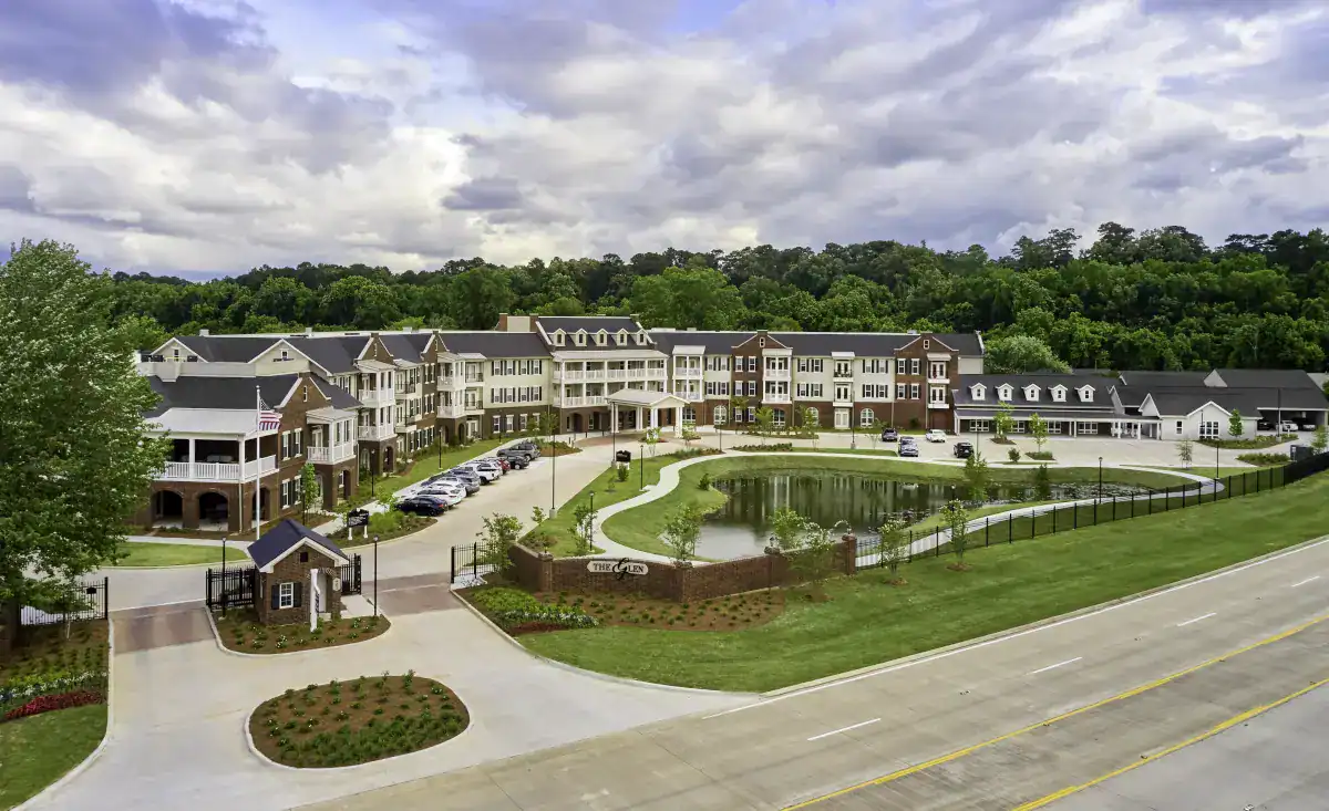 Aerial view of a senior living facility with pond