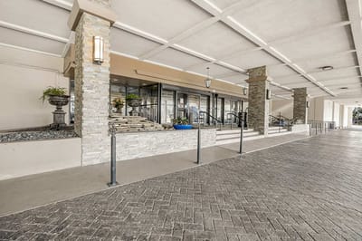 Entrance of Copeland Tower Living with stone columns
