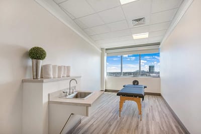 Interior view of a therapy room with a treatment table