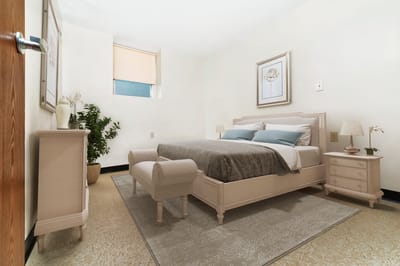 A well-appointed resident room with a bed and decor