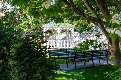 A serene garden area with benches and a gazebo