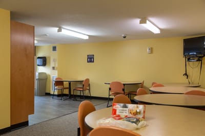 A dining area with tables and food trays