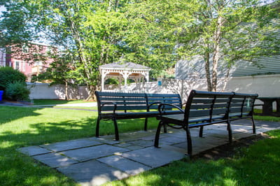 Outdoor seating area with a gazebo in the background
