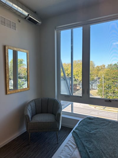 A cozy resident room with a view and armchair