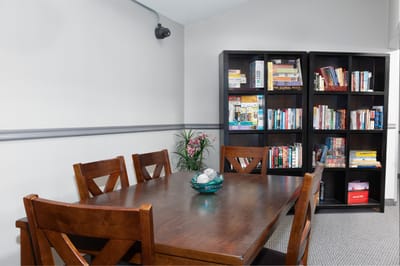Interior Common Area with Bookshelf and Table