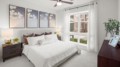 Brightly decorated resident bedroom with natural light