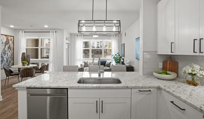 Modern kitchen view with living area in the background