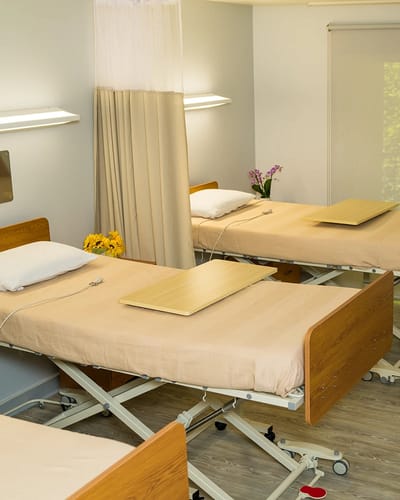 Interior view of a resident's room with beds and decor