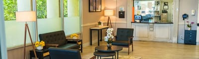 Bright lounge area with seating and flowers