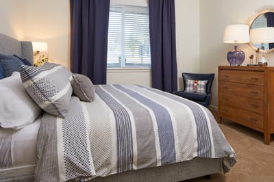 Cozy resident room with bedding and furnishings