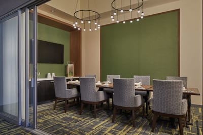 A well-furnished dining room with a large table and chairs