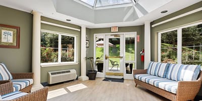 Bright common area with seating and large windows
