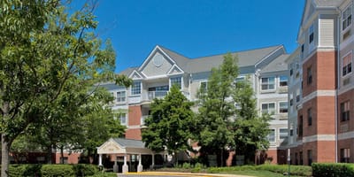 Exterior view of the Pin Oak Village facility with landscaping