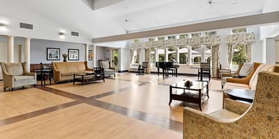 Bright common area with seating and a piano