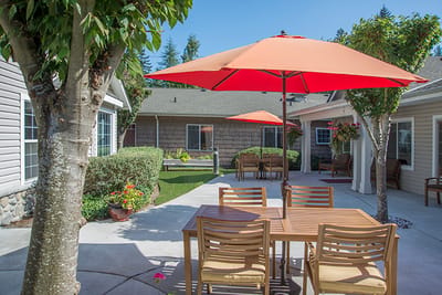 Outdoor patio area with seating and orange umbrellas.