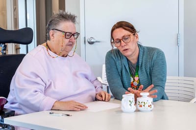 Resident and staff engaging in a conversation.