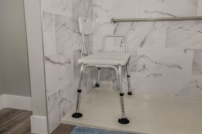 Shower chair in a tiled bathroom