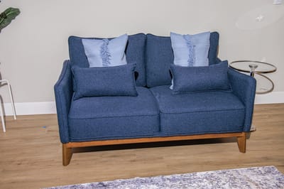 Cozy blue sofa with decorative cushions