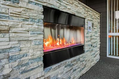 Modern outdoor fireplace with decorative stonework.