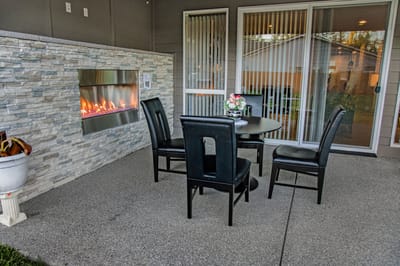 Patio area with a table and fireplace
