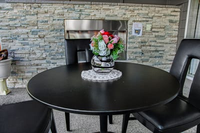 Outdoor table with a floral arrangement.