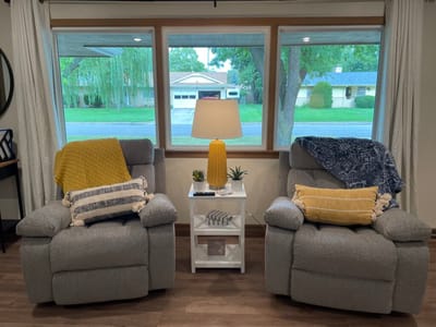 Cozy seating area with recliners and a lamp